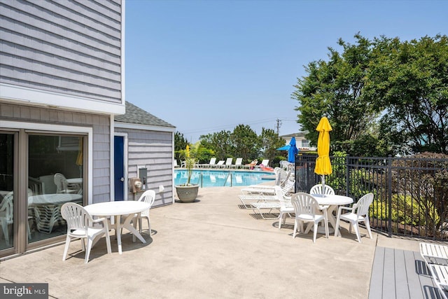 39770 E Sun Dr Unit 125, Fenwick Island, DE 19944 - view of patio / terrace with a community pool and outdoor dining space