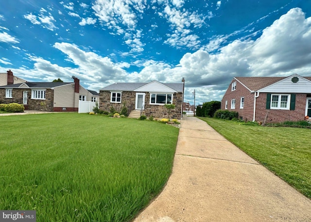 12008 Elmore Rd, Philadelphia, PA 19154 - view of front facade featuring a front lawn, driveway, stone siding, and entry steps