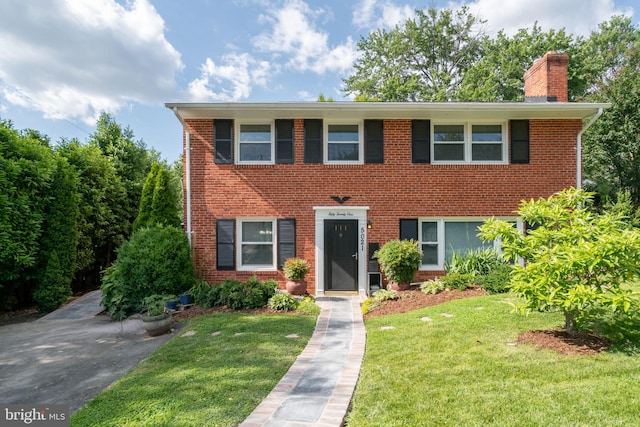 5021 23rd Rd N, Arlington, VA 22207 - colonial house with a front lawn, a chimney, and brick siding