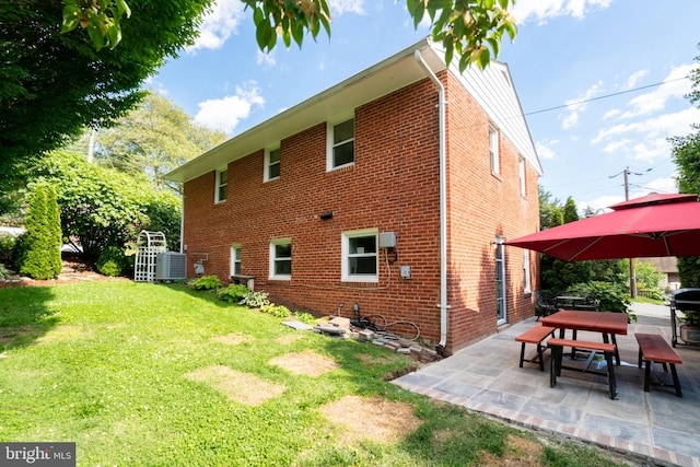 5021 23rd Rd N, Arlington, VA 22207 - back of house with central AC unit, a yard, brick siding, and a patio