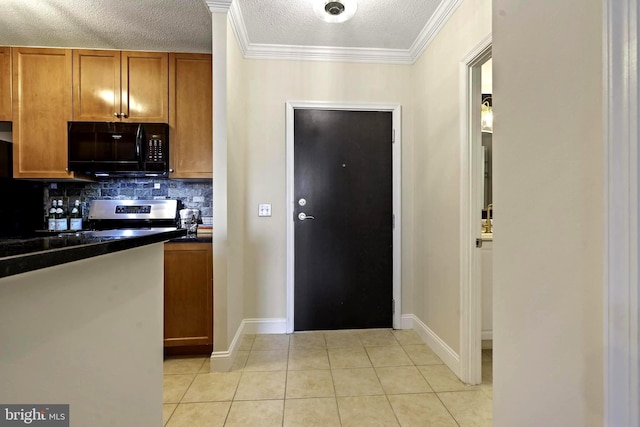 851 N Glebe Rd Unit 1103, Arlington, VA 22203 - kitchen with black microwave, light tile patterned floors, tasteful backsplash, dark countertops, and brown cabinets