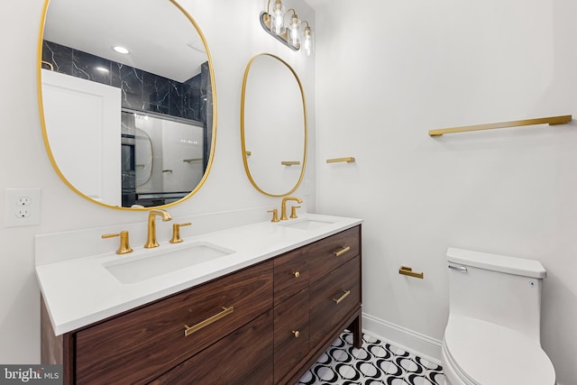 267 S Ellwood Ave, Baltimore, MD 21224 - bathroom featuring double vanity, toilet, baseboards, and a shower