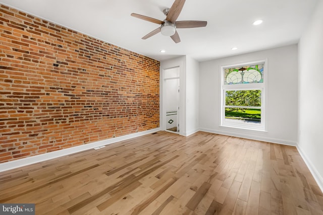 267 S Ellwood Ave, Baltimore, MD 21224 - unfurnished room featuring brick wall, a ceiling fan, baseboards, light wood-style flooring, and recessed lighting