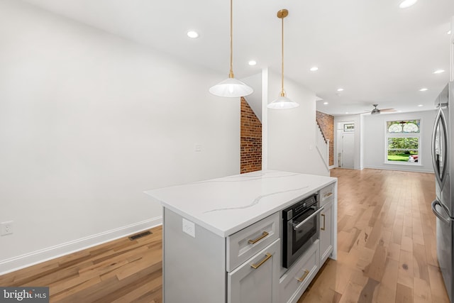 267 S Ellwood Ave, Baltimore, MD 21224 - kitchen with stainless steel appliances, light wood-style floors, a center island, open floor plan, and recessed lighting