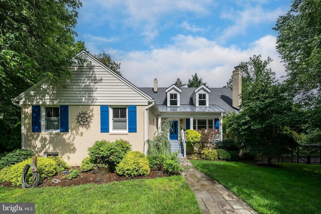 7016 Wilson Ln, Bethesda, MD 20817 - view of front facade with a chimney, a front yard, a porch, and brick siding