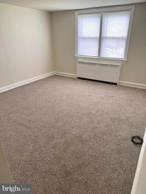 7113 Castor Ave, Philadelphia, PA 19149 - carpeted spare room featuring radiator heating unit, plenty of natural light, and baseboards