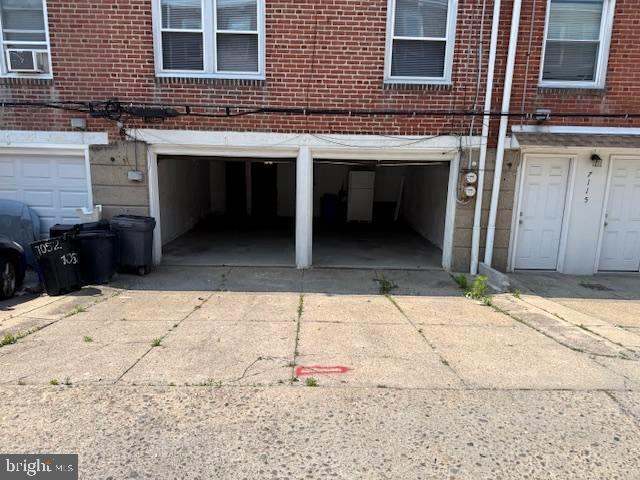 7113 Castor Ave, Philadelphia, PA 19149 - garage with driveway and cooling unit