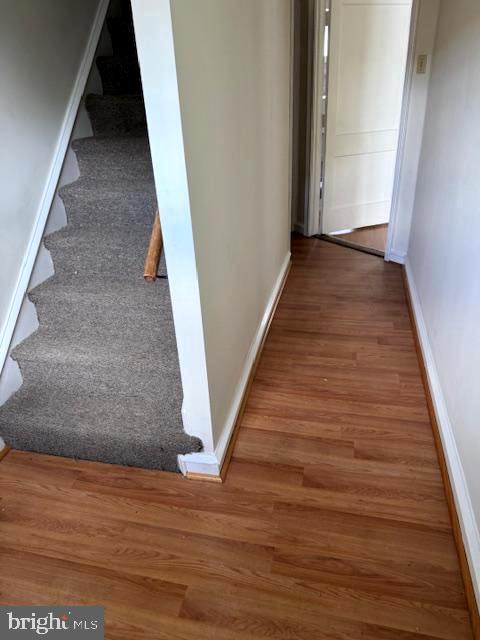 7113 Castor Ave, Philadelphia, PA 19149 - hallway featuring wood finished floors, baseboards, and stairway