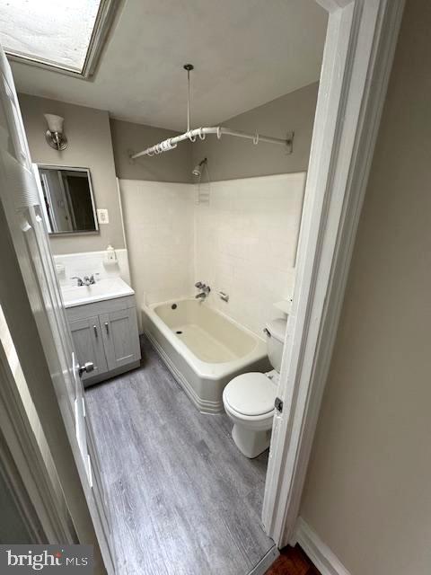 7113 Castor Ave, Philadelphia, PA 19149 - full bath featuring toilet, wood finished floors, vanity, and  shower combination