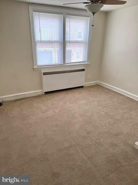 7113 Castor Ave, Philadelphia, PA 19149 - spare room featuring radiator, a ceiling fan, carpet floors, and baseboards
