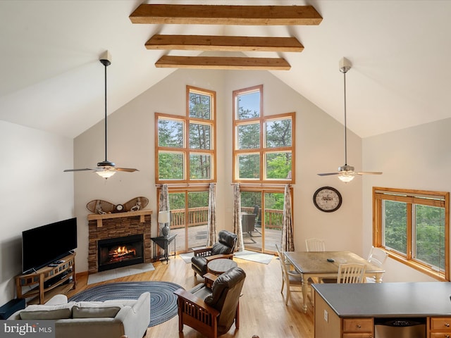 218 Nelson Way, Basye, VA 22810 - living room with ceiling fan, high vaulted ceiling, light wood-type flooring, a stone fireplace, and beamed ceiling