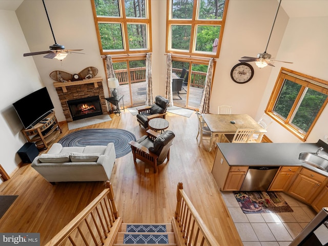 218 Nelson Way, Basye, VA 22810 - living area with a ceiling fan, a towering ceiling, light wood-style flooring, and a fireplace