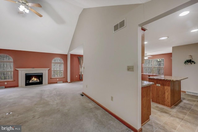 3115 Sparrow Ct, East Stroudsburg, PA 18302 - unfurnished living room with a ceiling fan, a lit fireplace, baseboards, recessed lighting, and high vaulted ceiling