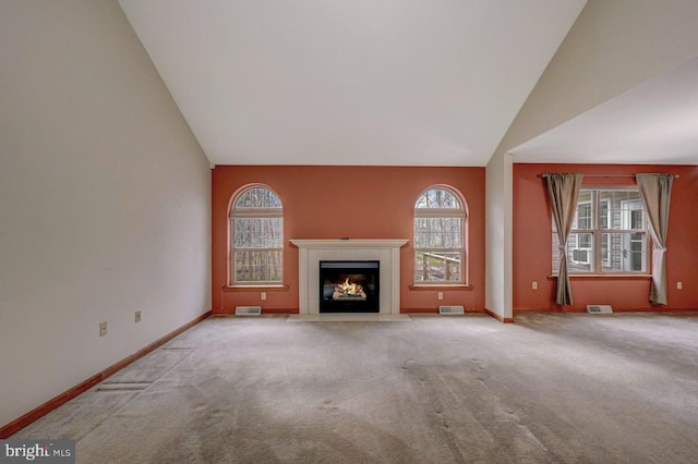 3115 Sparrow Ct, East Stroudsburg, PA 18302 - unfurnished living room featuring vaulted ceiling, a fireplace with flush hearth, carpet flooring, and baseboards
