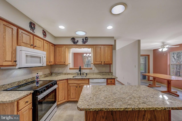 3115 Sparrow Ct, East Stroudsburg, PA 18302 - kitchen featuring white appliances, a sink, a kitchen island, light stone countertops, and ceiling fan