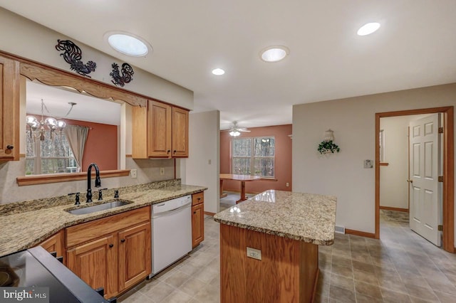 3115 Sparrow Ct, East Stroudsburg, PA 18302 - kitchen featuring white dishwasher, a sink, a center island, ceiling fan, and light stone countertops