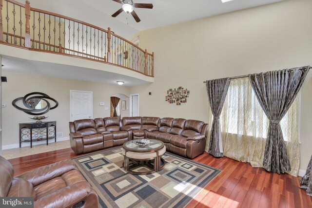 118 Connecticut Ave, Sinking Spring, PA 19608 - living room featuring ceiling fan, wood finished floors, a towering ceiling, arched walkways, and baseboards