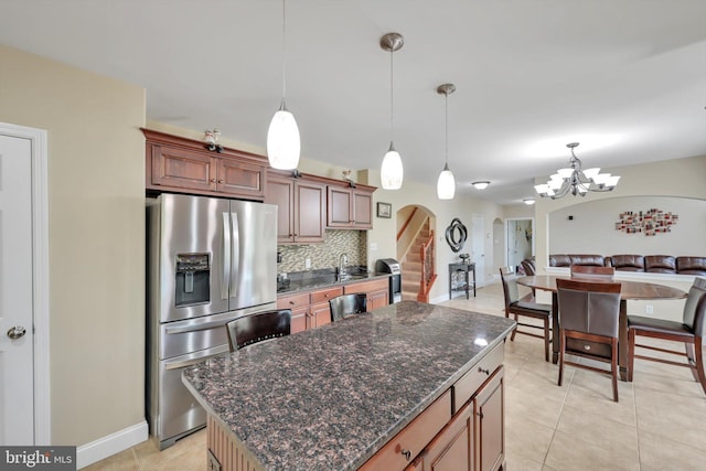 118 Connecticut Ave, Sinking Spring, PA 19608 - kitchen featuring stainless steel refrigerator with ice dispenser, arched walkways, a chandelier, light tile patterned flooring, and decorative backsplash