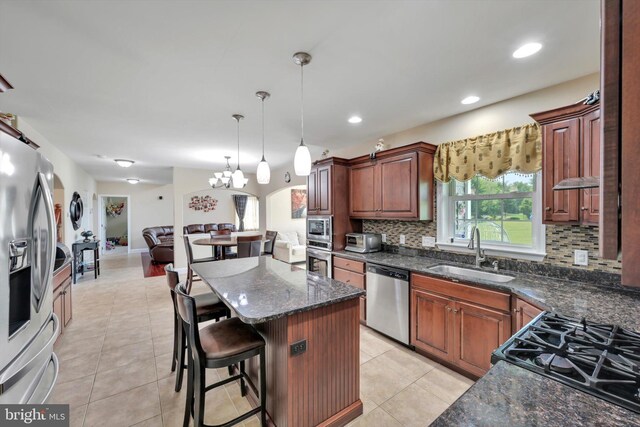 118 Connecticut Ave, Sinking Spring, PA 19608 - kitchen with appliances with stainless steel finishes, a sink, open floor plan, backsplash, and light tile patterned floors