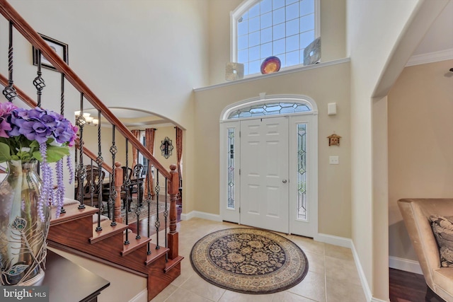 118 Connecticut Ave, Sinking Spring, PA 19608 - tiled foyer entrance featuring arched walkways, stairs, a high ceiling, and baseboards