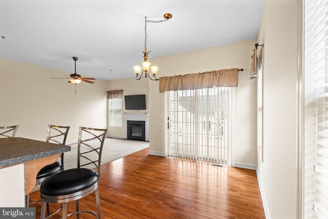 5529 Briar Ln, Whitehall, PA 18052 - dining area featuring wood finished floors, ceiling fan, a glass covered fireplace, and baseboards