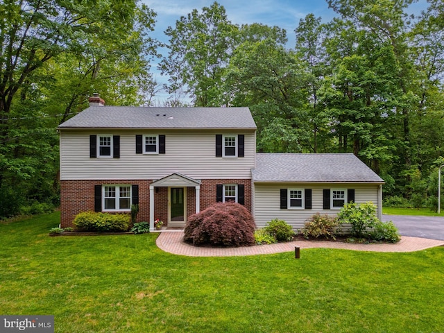 40 Grays Ln, Elverson, PA 19520 - view of front of property with a chimney, a front yard, brick siding, and roof with shingles