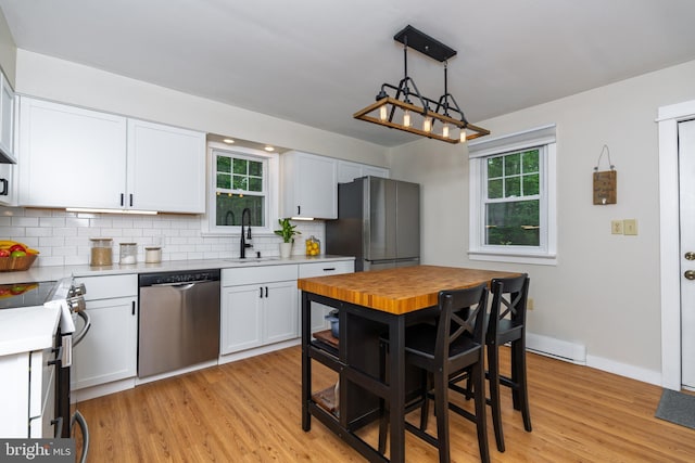 40 Grays Ln, Elverson, PA 19520 - kitchen featuring appliances with stainless steel finishes, a sink, light countertops, tasteful backsplash, and white cabinets