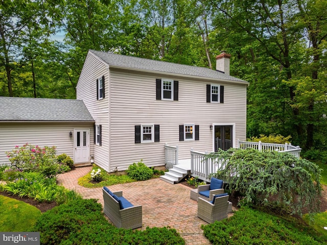 40 Grays Ln, Elverson, PA 19520 - rear view of house featuring a chimney, a deck, and a patio