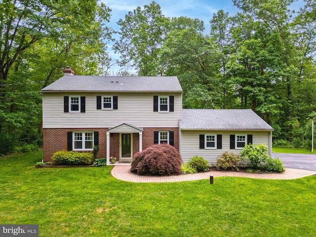 40 Grays Ln, Elverson, PA 19520 - view of front of home with a chimney, a front lawn, brick siding, and a shingled roof