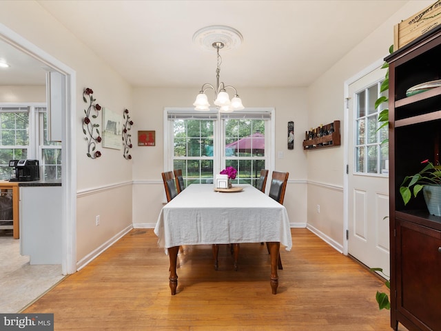 13610 Aden Rd, Nokesville, VA 20181 - dining room featuring a chandelier, light wood-type flooring, and baseboards