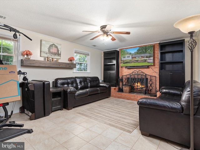 13610 Aden Rd, Nokesville, VA 20181 - living room featuring a brick fireplace, a ceiling fan, light tile patterned flooring, a textured ceiling, and ornamental molding