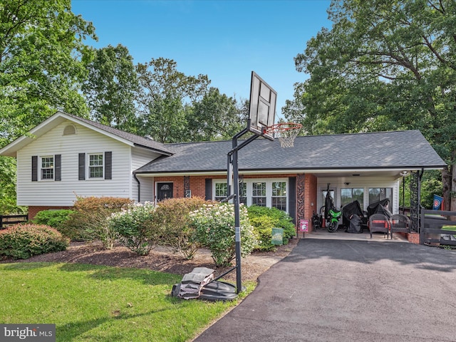 13610 Aden Rd, Nokesville, VA 20181 - tri-level home with roof with shingles, asphalt driveway, a carport, a front lawn, and brick siding
