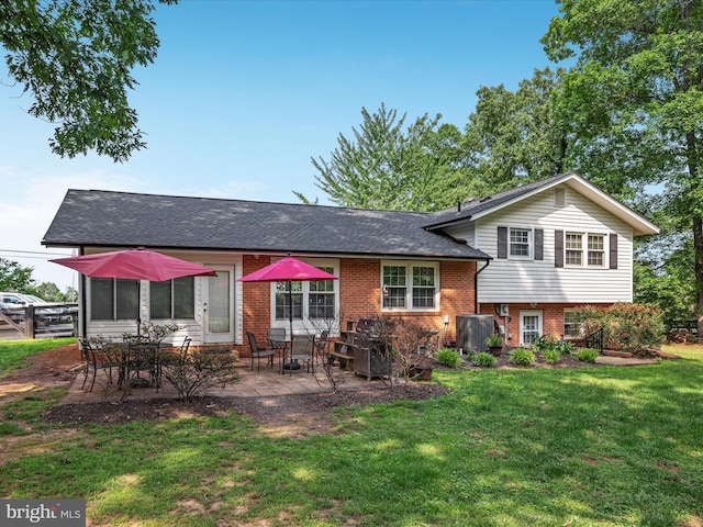 13610 Aden Rd, Nokesville, VA 20181 - back of property featuring brick siding, a lawn, a patio, and a shingled roof