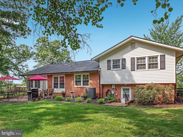13610 Aden Rd, Nokesville, VA 20181 - back of property featuring brick siding, a yard, a patio, and central AC unit
