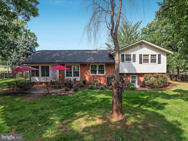 13610 Aden Rd, Nokesville, VA 20181 - split level home featuring a patio, brick siding, and a shingled roof