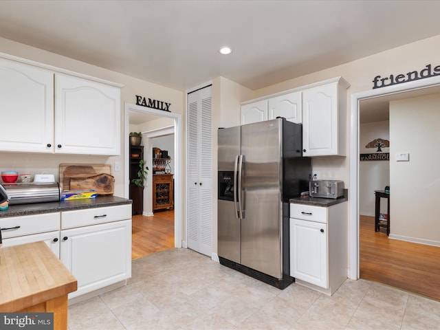 13610 Aden Rd, Nokesville, VA 20181 - kitchen featuring stainless steel fridge, white cabinetry, dark countertops, light tile patterned floors, and recessed lighting