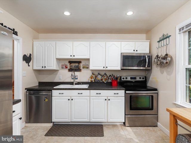 13610 Aden Rd, Nokesville, VA 20181 - kitchen with stainless steel appliances, a sink, white cabinetry, dark countertops, and recessed lighting
