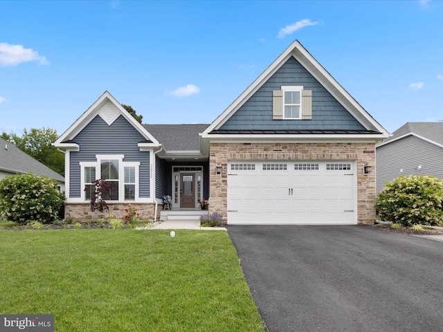 33512 Auburn Dr, Rehoboth Beach, DE 19971 - craftsman-style home featuring stone siding, asphalt driveway, a front yard, a standing seam roof, and a garage