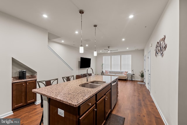 4524 Reaney Ln Unit 485, Owings Mills, MD 21117 - kitchen featuring a sink, stainless steel dishwasher, a breakfast bar, open floor plan, and dark wood-type flooring