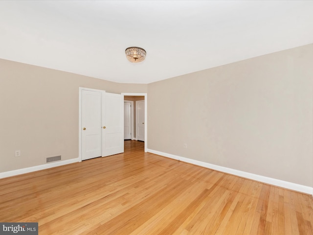 9905 Portland Rd, Silver Spring, MD 20901 - unfurnished bedroom featuring baseboards, light wood-type flooring, and a chandelier