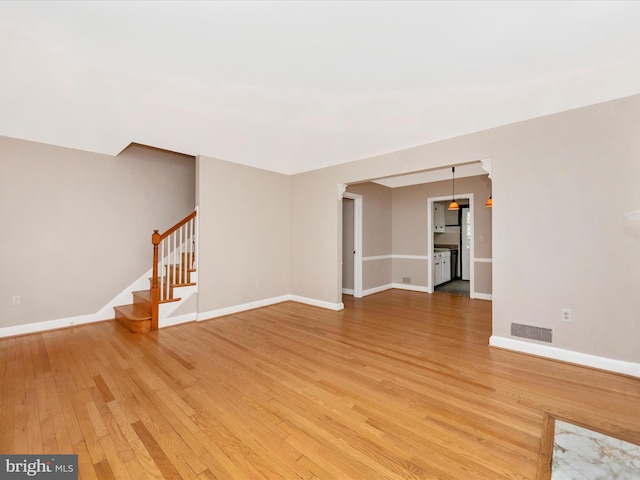 9905 Portland Rd, Silver Spring, MD 20901 - spare room featuring light wood-style floors, stairway, and baseboards