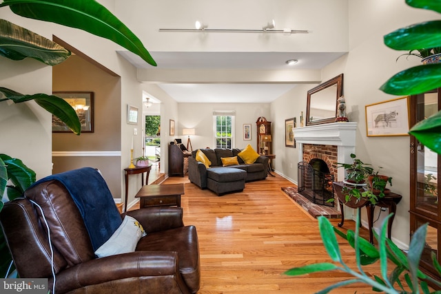 503 Emily Cir, West Chester, PA 19382 - living room with light wood-style floors, a brick fireplace, and baseboards