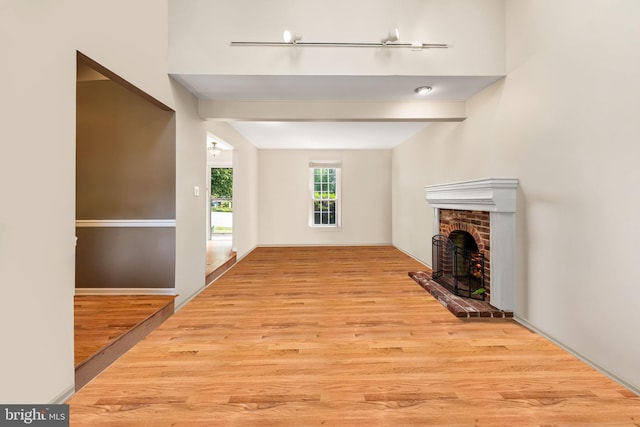 503 Emily Cir, West Chester, PA 19382 - unfurnished living room featuring a brick fireplace and wood finished floors