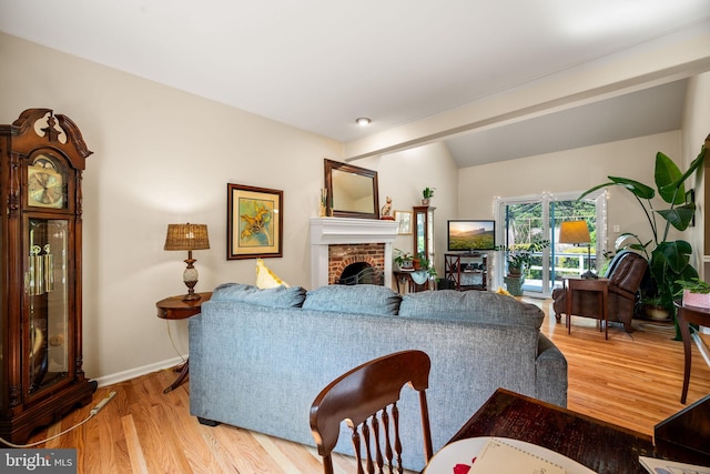 503 Emily Cir, West Chester, PA 19382 - living area with light wood finished floors, a fireplace, vaulted ceiling, and baseboards