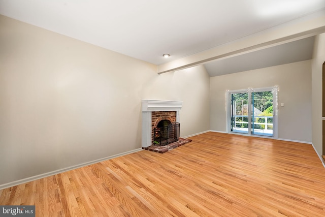 503 Emily Cir, West Chester, PA 19382 - unfurnished living room featuring light wood finished floors, baseboards, lofted ceiling, and a fireplace