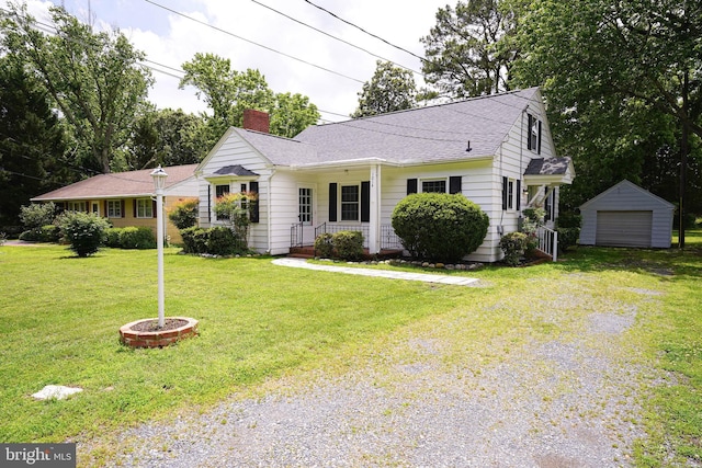 1014 Ellegood St, Salisbury, MD 21801 - view of front of house featuring a chimney, driveway, an outbuilding, a front yard, and covered porch