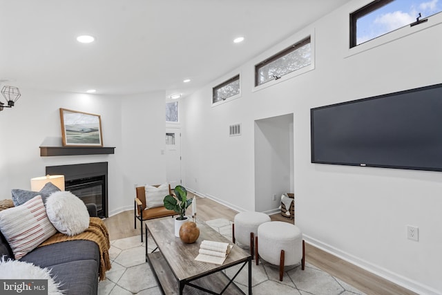6136 Sinbad Pl, Columbia, MD 21045 - living room with light wood-type flooring, a glass covered fireplace, recessed lighting, and baseboards