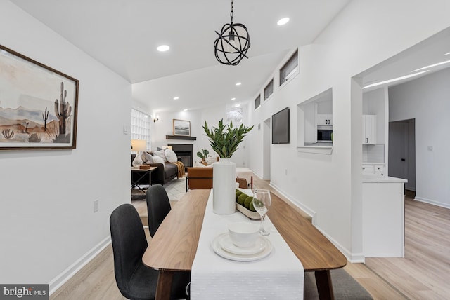6136 Sinbad Pl, Columbia, MD 21045 - dining area with light wood-type flooring, baseboards, recessed lighting, and a glass covered fireplace
