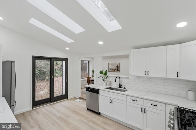 6136 Sinbad Pl, Columbia, MD 21045 - kitchen featuring a sink, appliances with stainless steel finishes, a skylight, backsplash, and white cabinetry