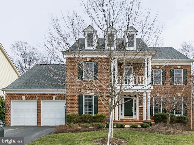 4788 Charter Ct, Woodbridge, VA 22192 - view of front of home featuring brick siding, a garage, asphalt driveway, and a balcony